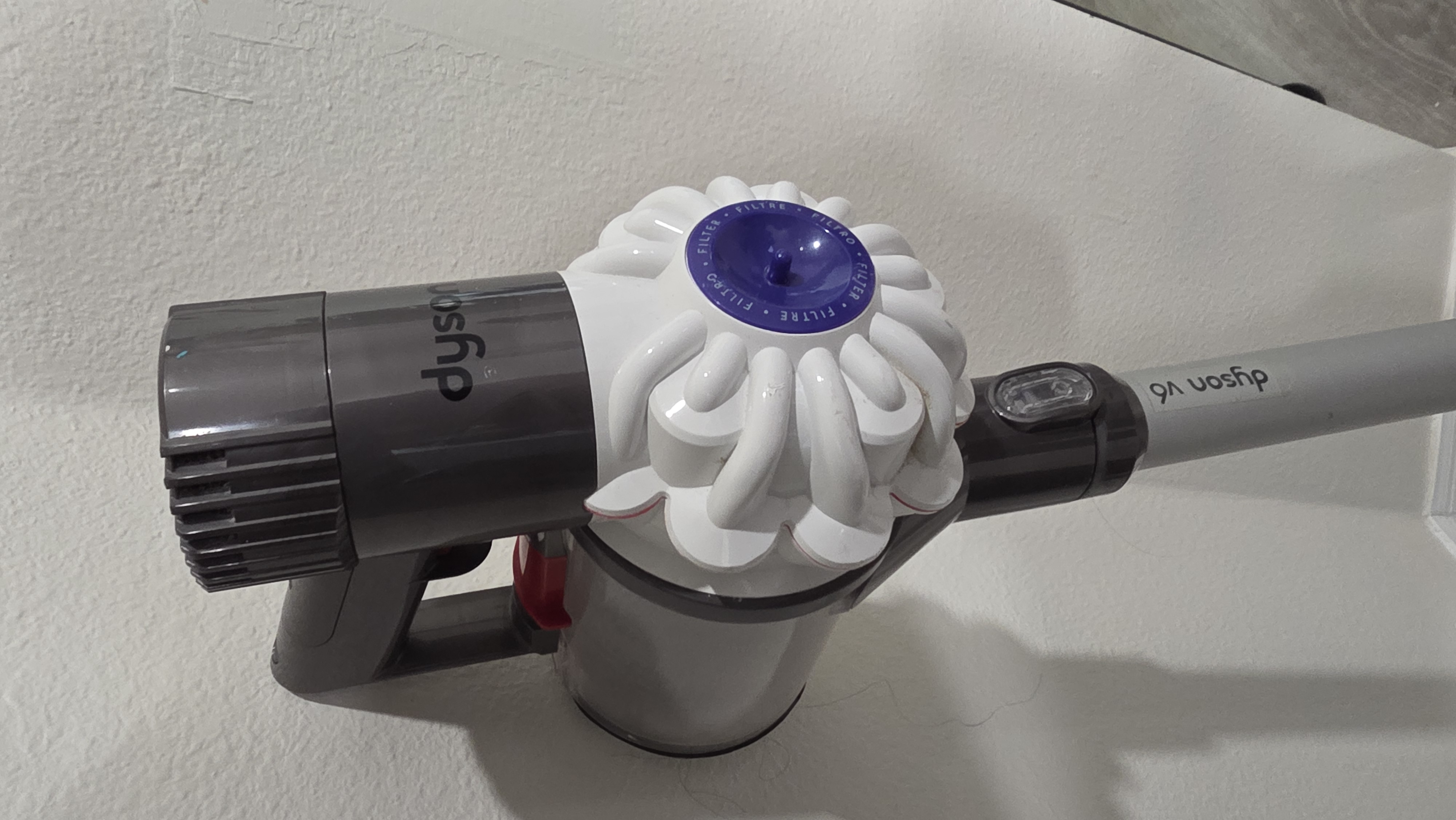 I know not everyone buys into the whole "Dyson is King" hype with cordless stick vacuums. But look, Dyson didn't just wake up and claim that crown—they earned it through tried-and-true engineering that's proven itself over time. Instead of constantly starting from scratch, Dyson makes minor tweaks to improve performance while keeping the core platform solid.
Compare that to Shark. Shark goes through radical redesigns every few years. Take their "Vertex" lineup, for example: if you Google "Shark Vertex," you won't even find the exact model I'm talking about anymore because they've already swapped it out for a completely different iteration. Like... what the actual HELL?!
Meanwhile, look at the Dyson V8. The core V-series design has stayed virtually identical for a decade because the platform actually works. Now, when measuring the intake port on the Dyson V6, you start to see some initial similarities to the Shark. The V6's intake port clocks in at around 30mm—basically the same width as the Shark's. But the difference is the airflow path. Because the Shark tries to be a million different devices in one, it forces debris through a complex, twisting path that can clog in multiple spots. The Dyson keeps it simple: a straight shot directly into the dustbin.
On top of that, the Dyson only uses a single roller that pops right out, making it effortless to clear if a obstruction ever occurs. The Shark has multiple clog zones in the cleaning head alone, including a secondary roller that you literally cannot remove. I'm not saying the Dyson is 100% clog-free—it can still get jammed. The real difference is how the Dyson and Shark handle larger items like popcorn. The Dyson uses a low front bumper that physically prevents large debris from reaching the roller in the first place. The Shark takes a "macho" approach: “SURE! I’LL HIT ANYTHING! I’LL SUCK IT ALL UP!” ...and then immediately chokes and clogs right at the head's intake pathway.
I’ve owned my Dyson V6 for over ten years, and it runs JUST as well today as the day I bought it. All I’ve ever had to swap out is the filter and the battery pack—and I even threw on an adapter so I can run it off my 18V Ryobi power tool batteries for hours on end! On top of that, I still have an old-school handheld Dyson DC34 running on its ORIGINAL factory battery pack, and after 10-plus years, that thing is still kicking!
Dyson is hands-down a vastly superior machine to anything Shark is pumping out. Since Dyson doesn't produce the V6 anymore, the V8 is the absolute sweet spot if you want that same legendary reliability. And for the record: Dyson hasn't paid me a single dime or sent me free gear. This is just straight-up real-world advice from someone who has beat the hell out of both brands. — view 1
